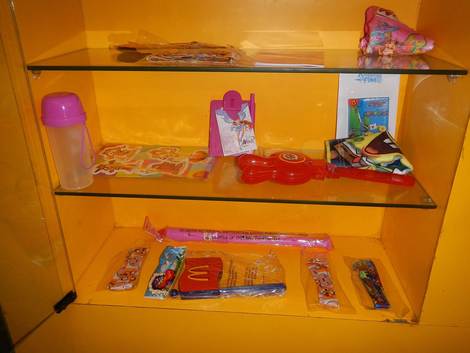 Vitrine mit mehreren verpackten Happy-Meal-Spielzeugen einer Serie in einem McDonald’s-Restaurant